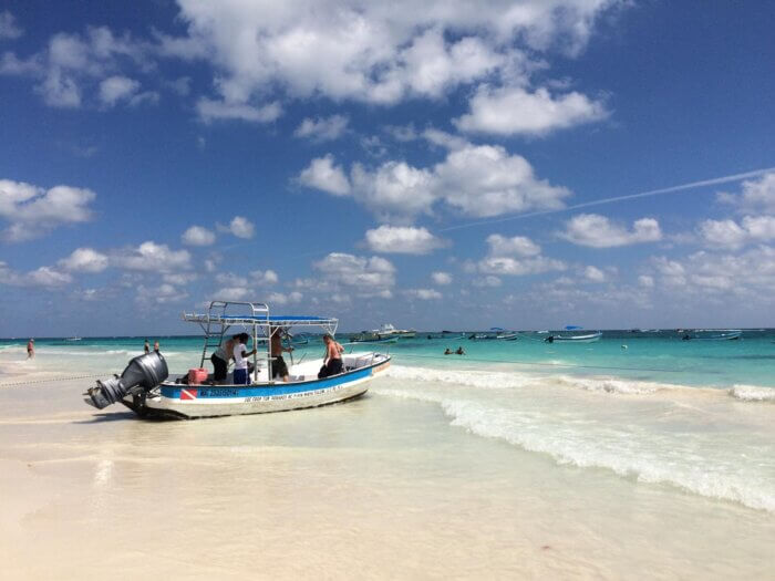 Člun na tyrkysovém karibiku na pláži Playa pescadores v Tulum v Mexiku